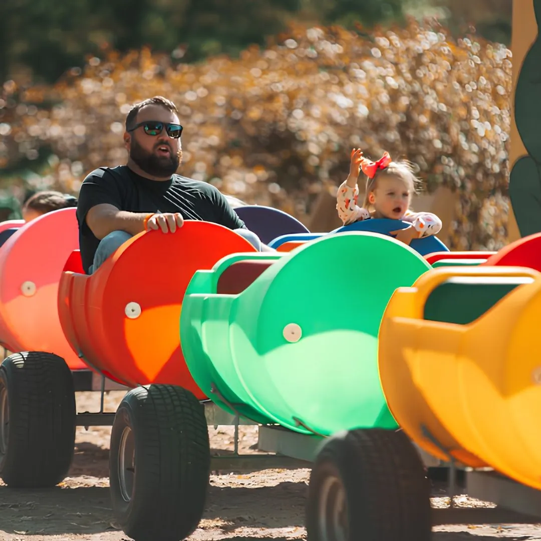 Children riding the barrel train during Fall Family Fun Days