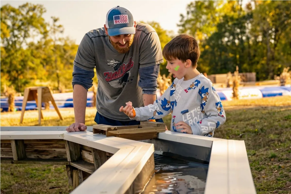 Adult and child enjoying a hands-on farm activity at Callaham Orchards