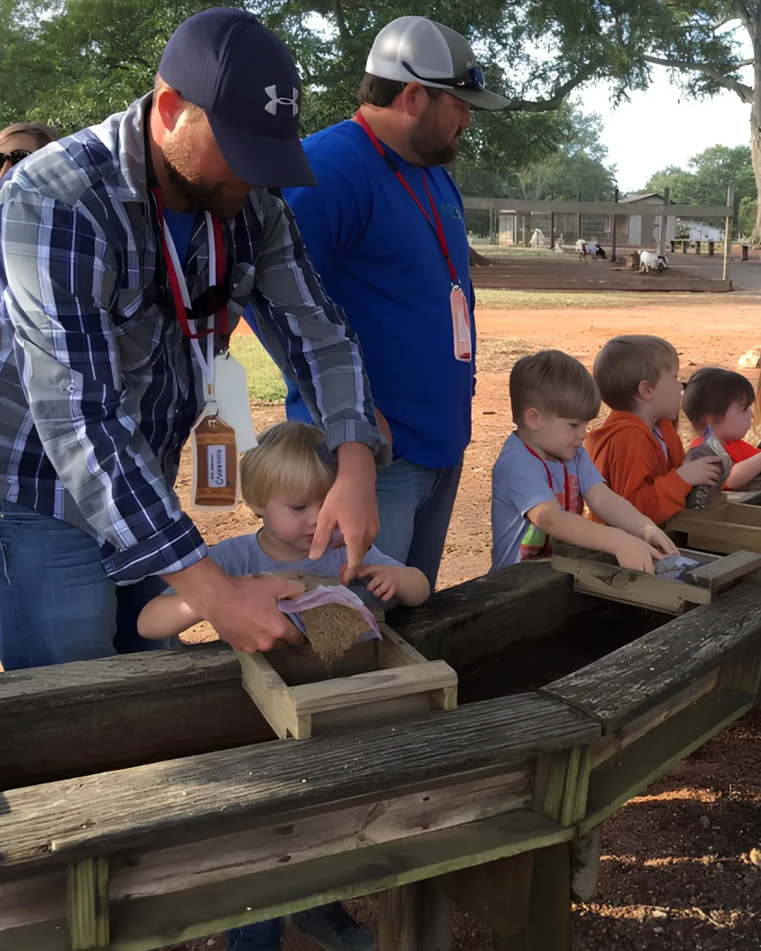 Adult and child enjoying a hands-on farm activity