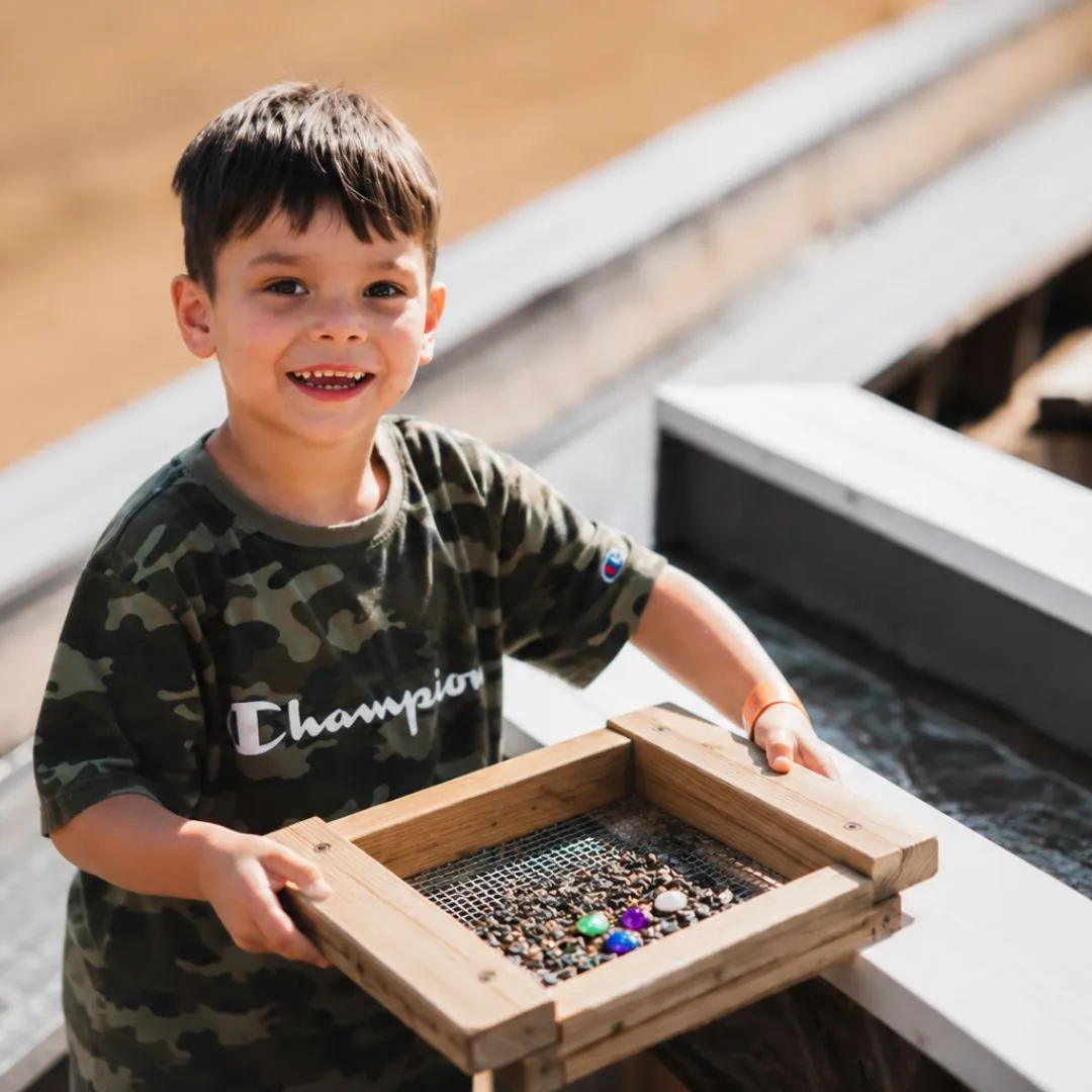 Gem Mining Child sifting for gems at the gem mining station