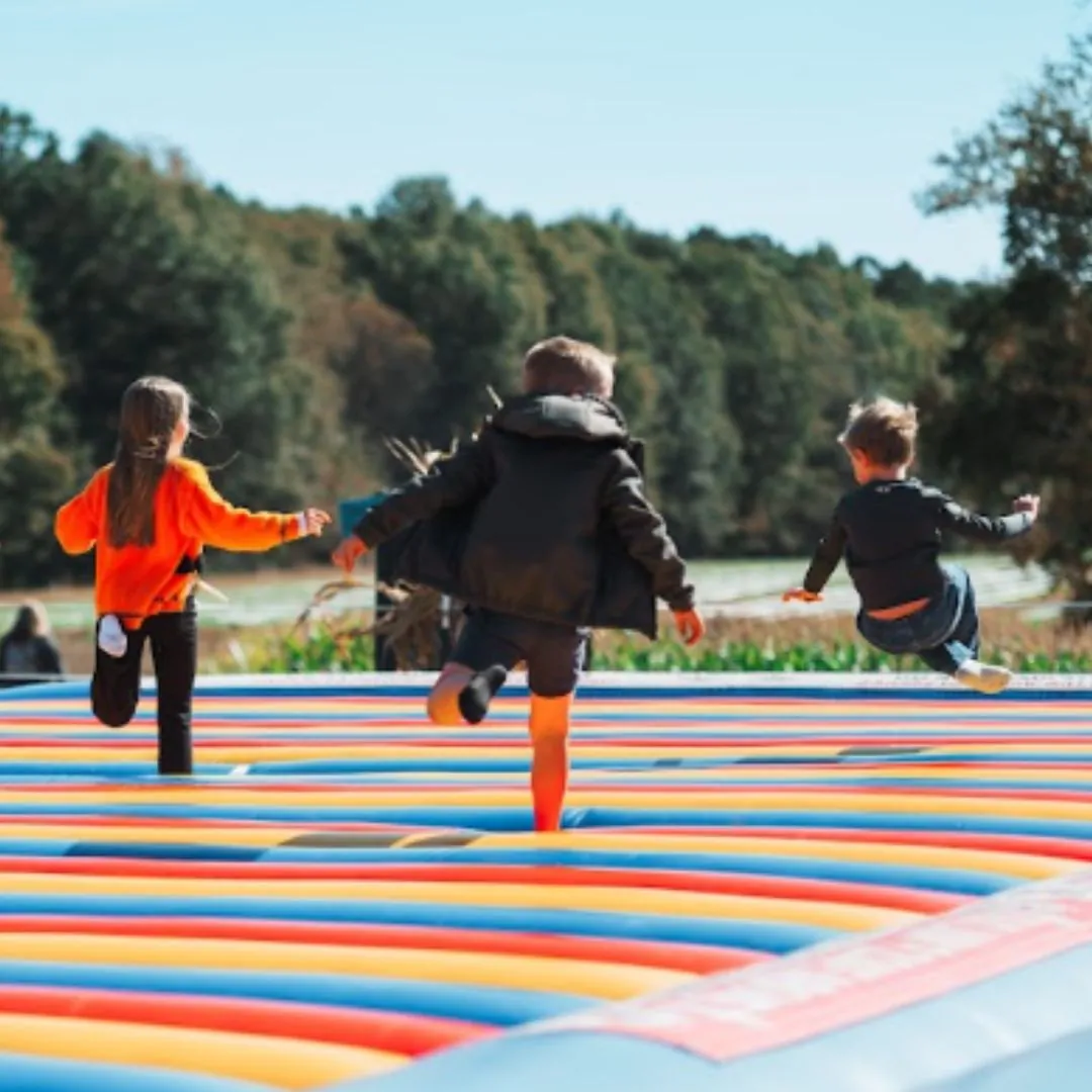 Kids bouncing on the giant jump pad